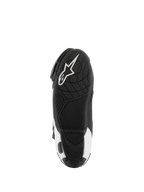 Bottes Alpinestars Supertech R Vented, bottes de course moto, noir et blanc, vue de dessous de la semelle présentant un grip en caoutchouc texturé et le logo Alpinestars blanc