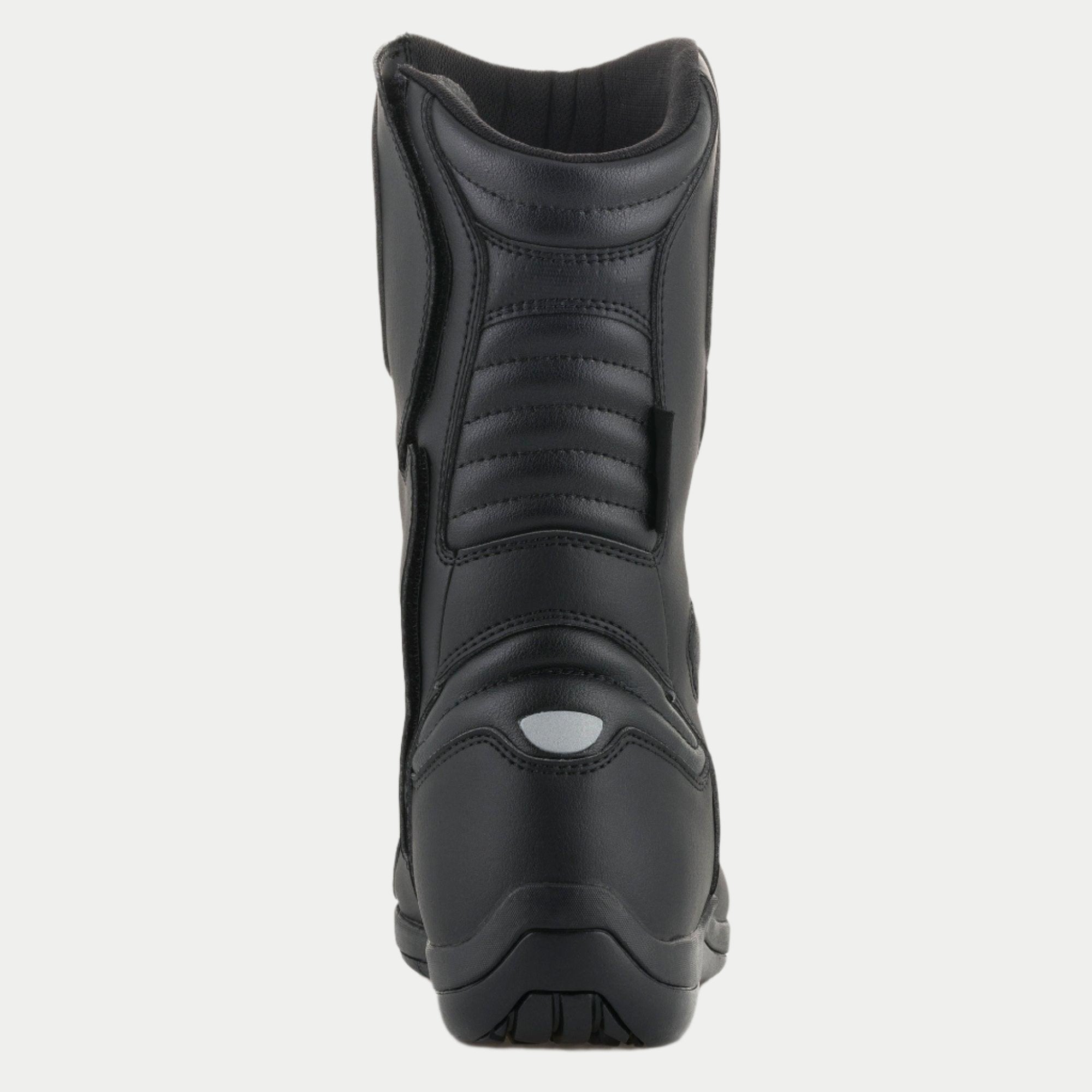 Bottes Alpinestars Origin Drystar®, bottes de moto touring, noires, vue arrière avec zones de flexion en accordéon sur le tendon d'Achille et le mollet, détail réfléchissant au talon et construction en microfibre durable
