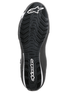 Chaussures Alpinestars Sektor, chaussures de moto, noir et blanc, vue de dessous de la semelle en caoutchouc texturée avec motif ondulé, logo Alpinestars blanc et symbole de l'étoile.