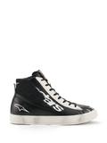 Chaussures Alpinestars Stated Flair, chaussures de moto urbaines, noir et blanc, construction montante en cuir avec grand logo blanc sur le côté, panneau d'œillets blanc perforé, fermeture éclair latérale et semelle en caoutchouc blanc avec patine vintage usée