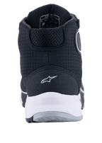 Chaussures de moto Alpinestars CR-X Drystar®, noir et blanc, vue arrière montrant la semelle intermédiaire blanche et le logo au talon, tige en textile texturé avec construction montante protectrice, conçues pour la conduite moto imperméable et le confort de marche