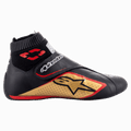Alpinestars Supermono V2 Shoes FIA, Auto Racing Shoes, Black Gold and Red, side profile view showing leather construction with perforated panels, large gold star logo, elastic sock-style fireproof collar, and a hook-and-loop closure strap.