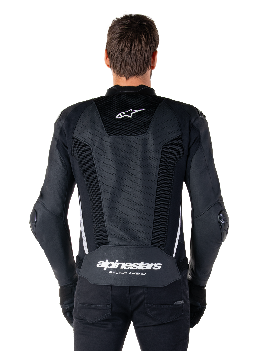 Veste en cuir Alpinestars Missile V3 Airflow, Noir et Blanc, vue de dos portée par un pilote, dotée de larges panneaux en cuir perforé, d'accents latéraux blancs, du logo étoile Alpinestars sur le haut du dos et du marquage « alpinestars RACING AHEAD » sur le bas du dos.