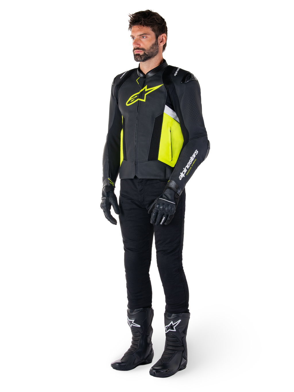 Modèle masculin portant la veste en cuir Alpinestars Missile V3 Airflow en noir, jaune fluo et blanc, associée à des gants, un pantalon et des bottes de moto noirs, mettant en valeur la conception en cuir perforé et l'esthétique inspirée de la course.