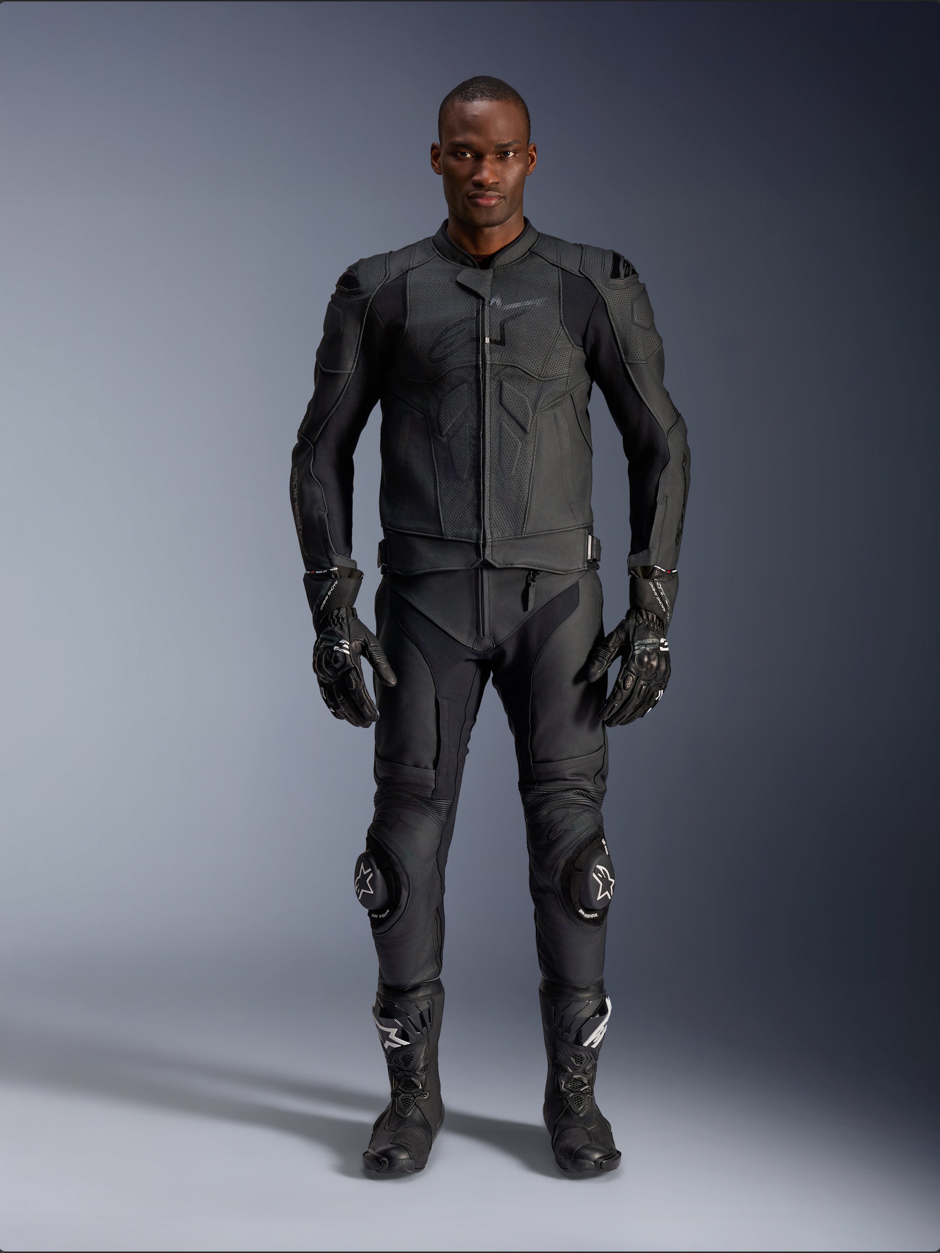 Alpinestars Dusk Airflow Leather Jacket, Black, worn with matching motorcycle pants, gloves, and boots, featuring perforated leather for maximum airflow, ergonomic multi-panel design, and internal armor, professional road and sport riding gear