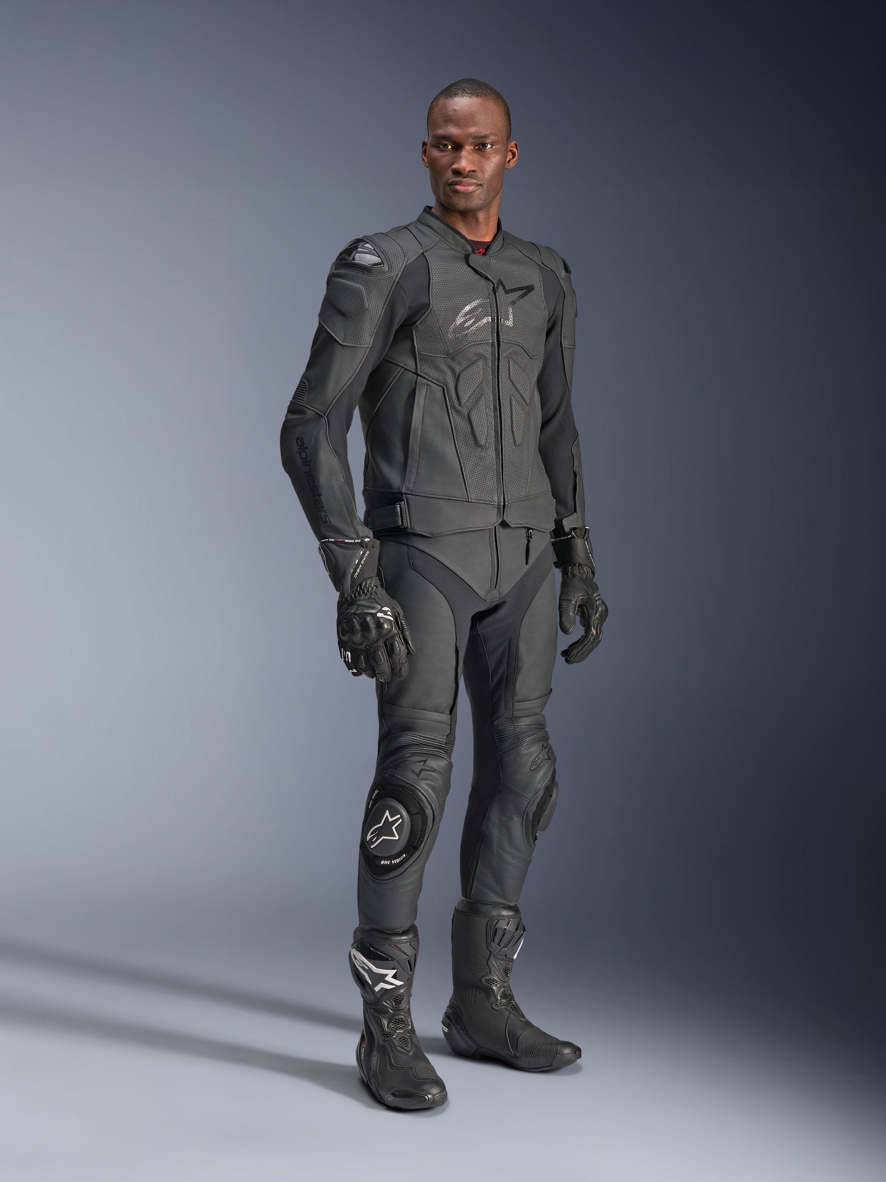 Alpinestars Dusk Airflow Leather Jacket, Black Black, worn by a rider in full technical gear including matching leather pants, gloves, and boots, featuring perforated leather panels for ventilation and integrated armor for sport motorcycle riding