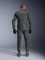 Male model shown from the back wearing the Alpinestars Dusk Airflow Leather Jacket in Black, paired with matching black leather racing pants, gloves, and boots, featuring extensive perforations for ventilation and the Alpinestars logo on the lower back.