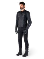 Veste en cuir Alpinestars Faster V3, Noir Noir, portée avec un pantalon, des gants et des bottes noirs, construction en cuir technique avec panneaux extensibles HRSF, protections d'épaules DFS GP Lite intégrées et silhouette sportive épurée