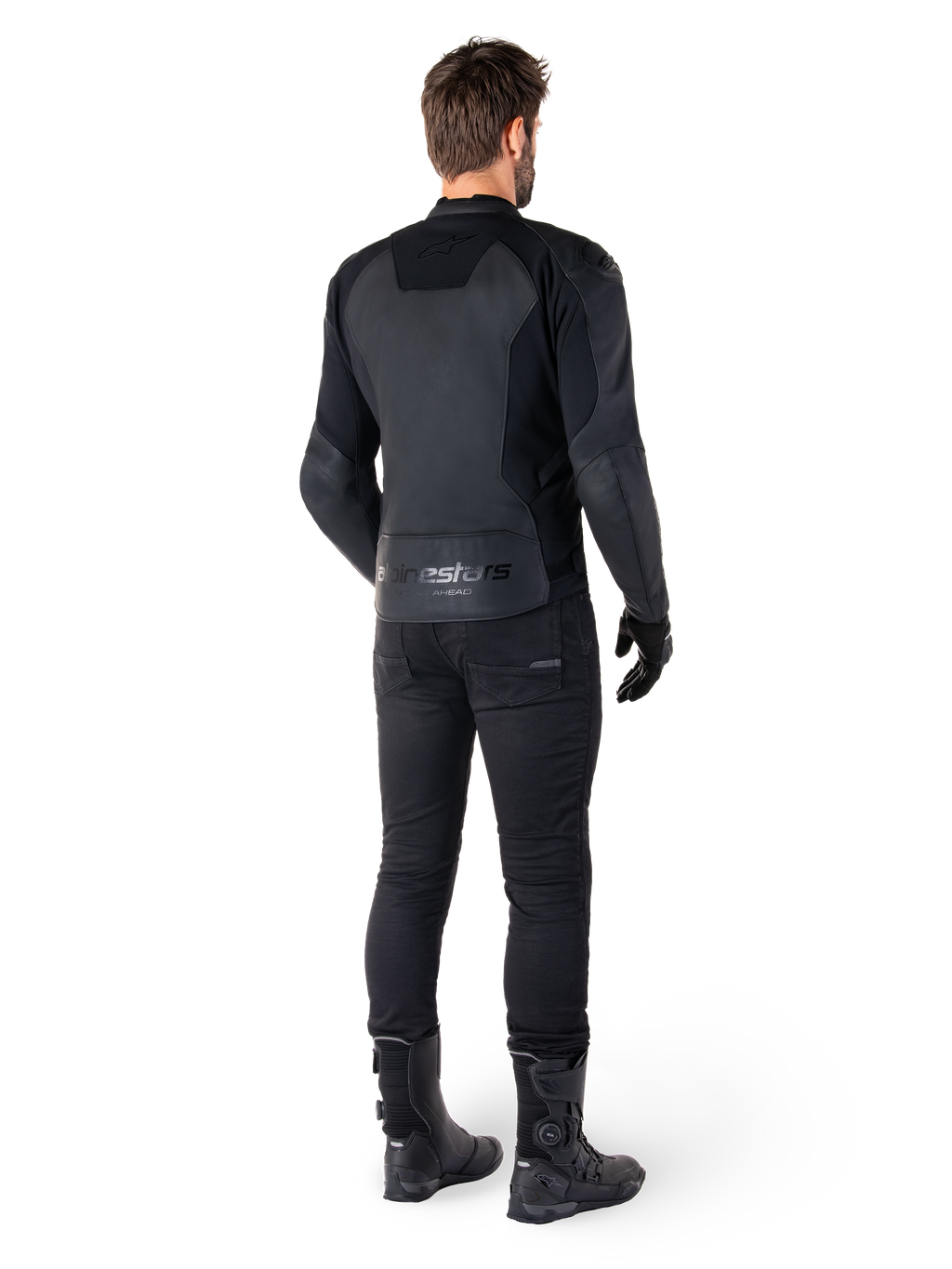 Veste en cuir Alpinestars Faster V3, Noir Noir, vue arrière sur un pilote, avec des panneaux en cuir haut de gamme et un marquage Alpinestars embossé, associée à un pantalon et des bottes de moto noirs pour un look de moto sportive complet.