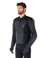 Model wearing the Alpinestars Faster V3 Airflow Leather Jacket in Black Black, sport riding motorcycle jacket with perforated leather and stretch panels, paired with black pants and black gloves with red accents, sleek race-derived style.