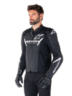 Alpinestars Faster V3 Airflow Leather Jacket, Black and White, sport motorcycle jacket with perforated leather panels, white Alpinestars branding on chest and arms, worn by a model with black gloves and pants, sleek and protective riding gear