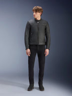 Alpinestars Dyno Leather Jacket, Black, worn by a male model with black trousers and black boots, premium leather motorcycle jacket with a minimalist heritage design, standing full-body view