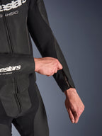 Alpinestars GP Force V2 Leather Suit 2-Piece, combinaison de moto en cuir noir, gros plan sur l'ajustement de l'ouverture zippée de l'avant-bras, avec des panneaux en cuir perforé et une construction en tissu extensible.