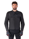 Alpinestars T-Jaws V4 Waterproof Jacket, Black Motorcycle Sport Jacket, worn by a man with black gloves featuring red accents, reinforced shoulders and arms, sleek design with subtle chest logo, textile all-weather riding gear