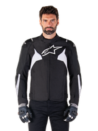 Alpinestars T-Jaws V4 Waterproof Jacket, noir et blanc, veste de moto sport en textile pour homme, logo étoile blanc sur la poitrine, accents blancs aux épaules et bandes blanches sur les avant-bras, col haut, coupe athlétique pour la route
