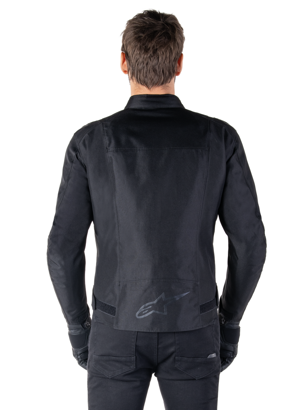Veste Alpinestars T-SPS V2 Waterproof, noir, vue de dos montrant la silhouette à coupe sport, logo Alpinestars réfléchissant sur le bas du dos, et dos allongé pour une couverture supplémentaire en position de conduite.