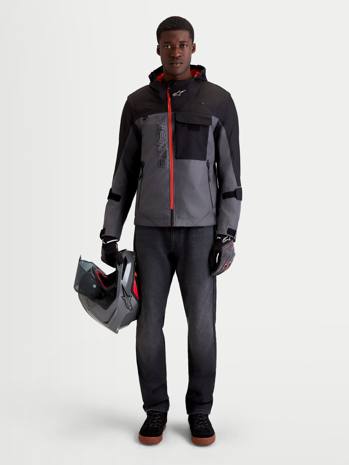 Alpinestars Morfex Parka Waterproof Jacket, men's urban contemporary motorcycle jacket in lunar gray and black, front view on a model wearing the jacket holding a helmet
