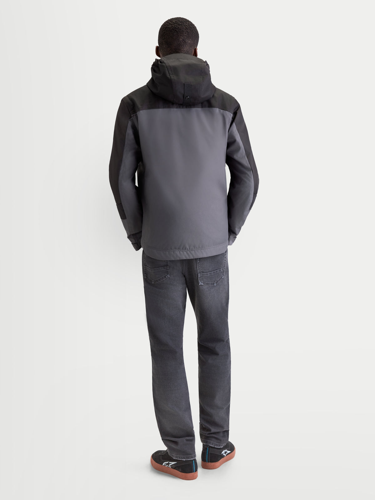 Alpinestars Morfex Parka Waterproof Jacket, men's urban contemporary motorcycle jacket in lunar gray and black, rear view on a model wearing the textile jacket with integrated hood.