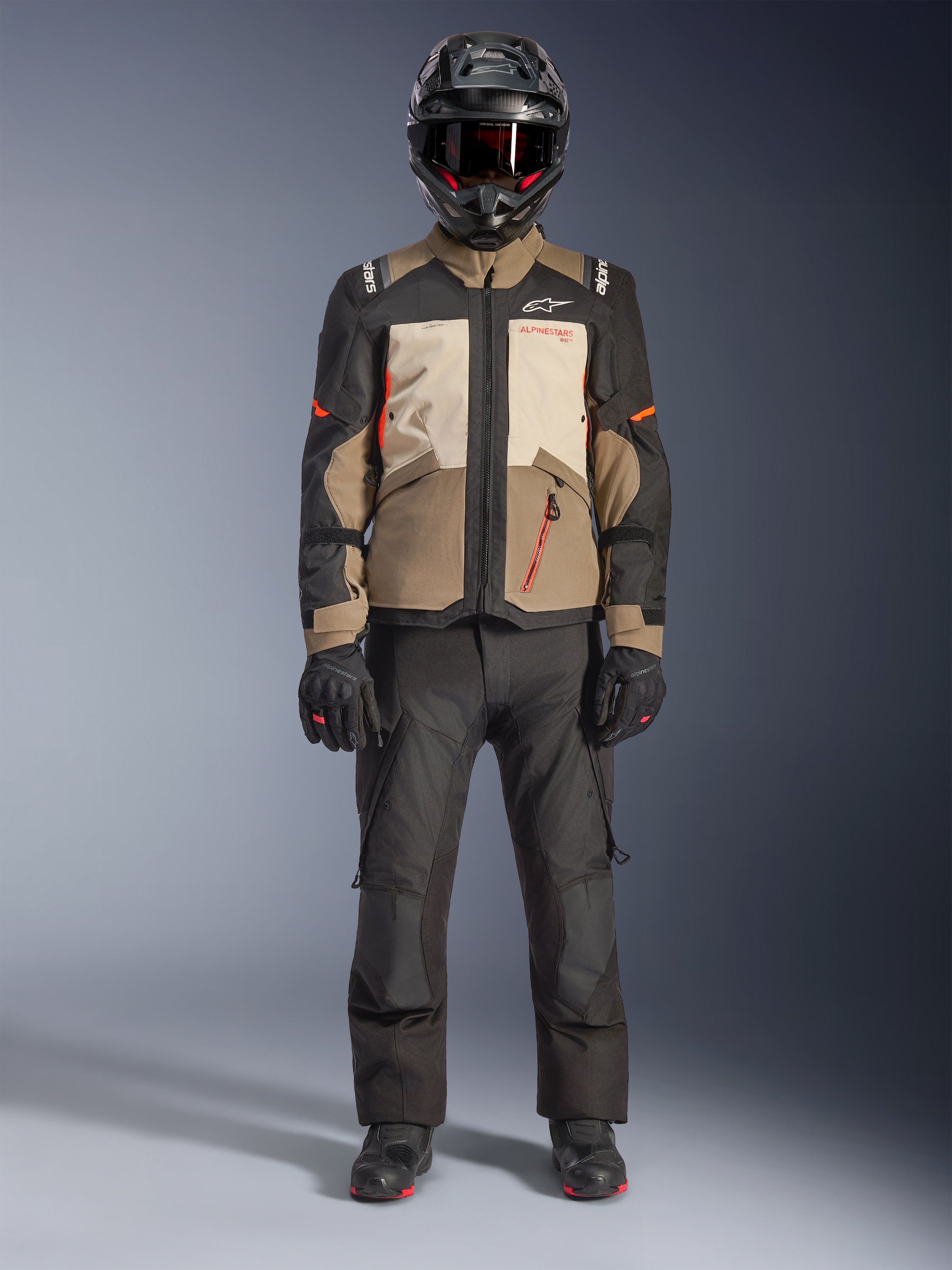 Alpinestars Andes V4 Drystar® Jacket, Walnut Mastic Black, adventure touring motorcycle jacket with tan and cream panels and orange accents, worn by a rider with a black adventure helmet, black riding pants, and black boots, full-body studio view