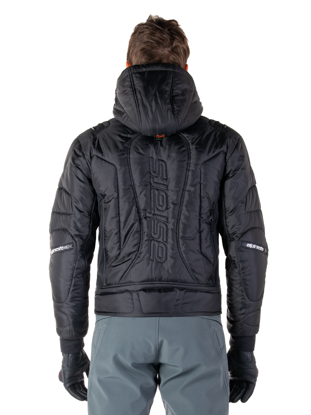 Veste Alpinestars Mohobbs Waterproof, noire, vue de dos montrant la construction matelassée rembourrée, mot-symbole 'astars' vertical au dos, capuche relevée, style moto streetwear contemporain