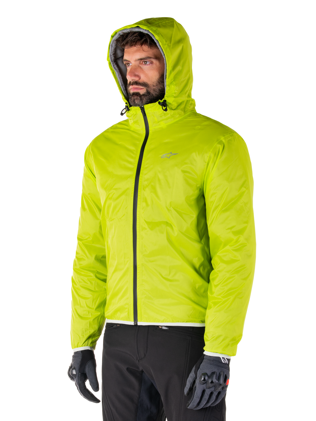 Alpinestars Mohobbs Waterproof Jacket, Lime Punch packable rain liner, bright neon green hooded jacket worn with black pants and gray gloves, urban streetwear-inspired motorcycle apparel