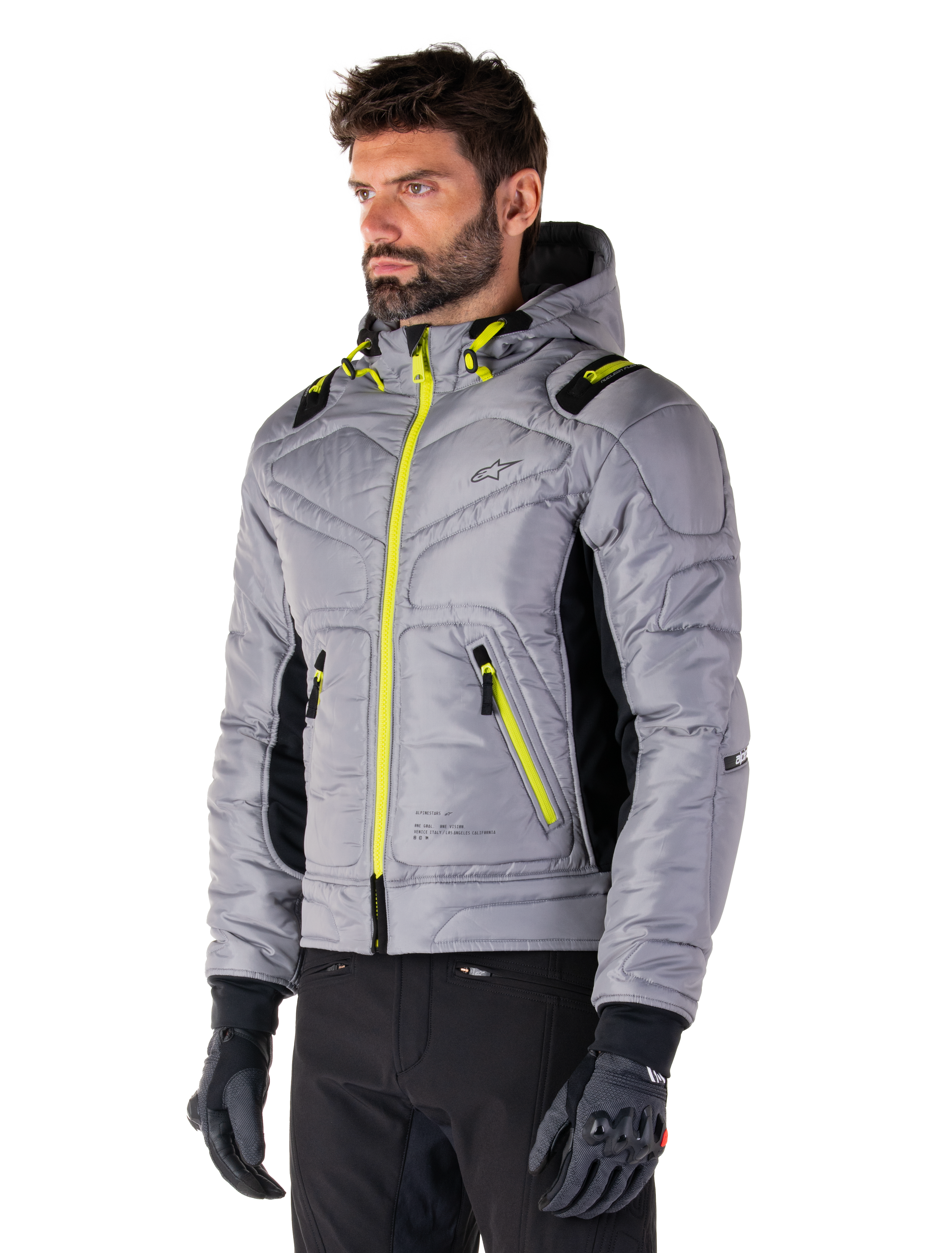 Alpinestars Mohobbs Waterproof Jacket, Lunar Gray Lime Punch, men's quilted bomber motorcycle jacket with neon yellow zippers and drawstring accents, worn with black riding pants and gloves, modern urban moto streetwear design with a hooded profile
