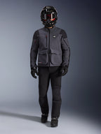 Alpinestars Maxdura Drystar®XF Laminated Armored Shell, adventure motorcycle jacket in Deep Gray and Black, worn with matching black riding pants, a black full-face helmet, gloves, and boots, featuring prominent cargo pockets and ALL TERRA branding for a technical off-road touring look