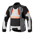 Alpinestars Halo Drystar® Jacket, Motorcycle Adventure Touring Jacket, Dark Gray, Ice Gray, and Black with Orange accents, featuring an asymmetric front ventilation panel, orange astars branding, adjustable sleeve straps, and high collar, protective textile gear for all-season adventure riding