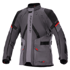 Veste Alpinestars Monteira Drystar XF, veste de moto touring, gris foncé et gris goudron avec empiècements noirs et touches de rouge vif, comprenant des poches cargo à l'avant, des sangles réglables à la taille et aux bras, un logo Alpinestars vertical et un col haut, conçue pour la conduite aventure