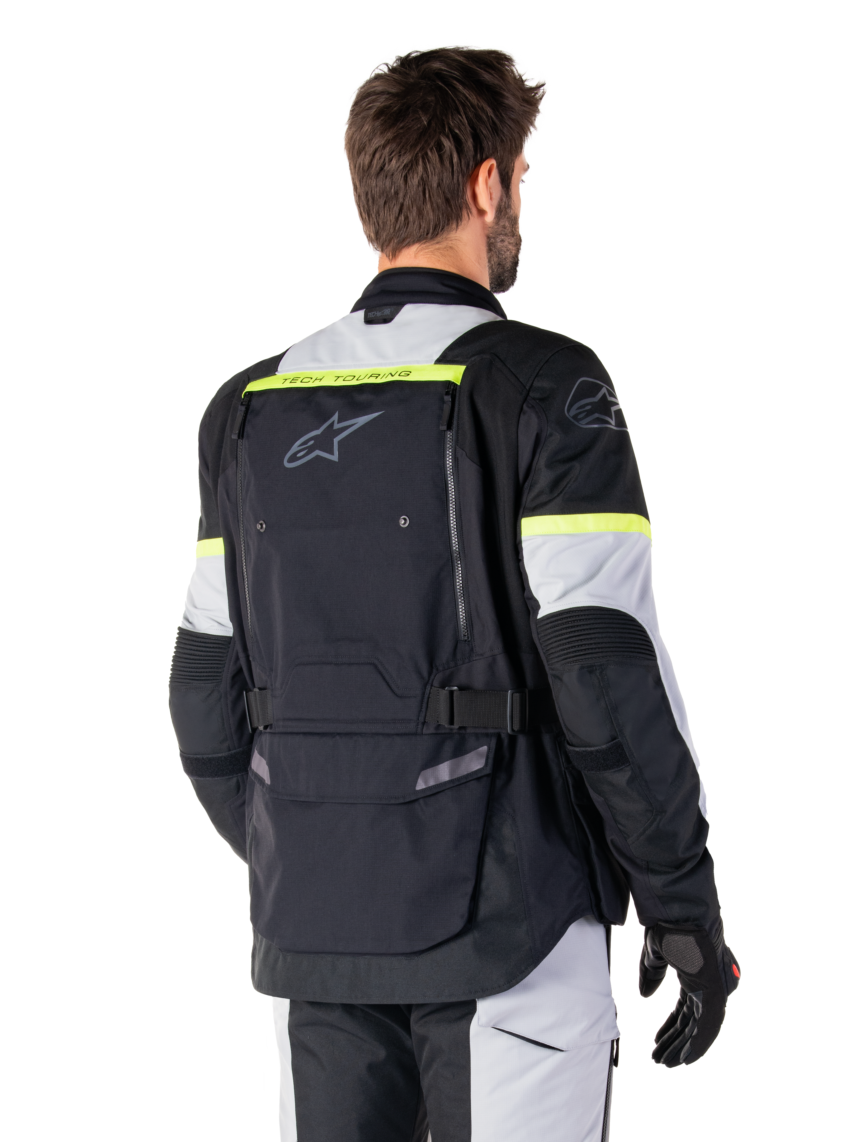 Veste Alpinestars Bogotá Pro Drystar®, veste de touring d'aventure, Noir, Gris Glace et Jaune Fluo, vue arrière montrant le grand panneau de poche arrière avec marquage 'TECH TOURING', logo Alpinestars et accents fluorescents, équipement moto technique en textile