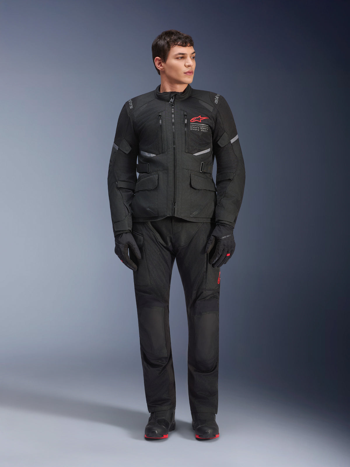 Alpinestars Andes Air Drystar® Pants, Motorcycle Touring Pants, Black, featuring mesh ventilation panels and a red logo on the leg, worn as part of a complete riding outfit with a matching jacket and gloves, professional adventure touring gear