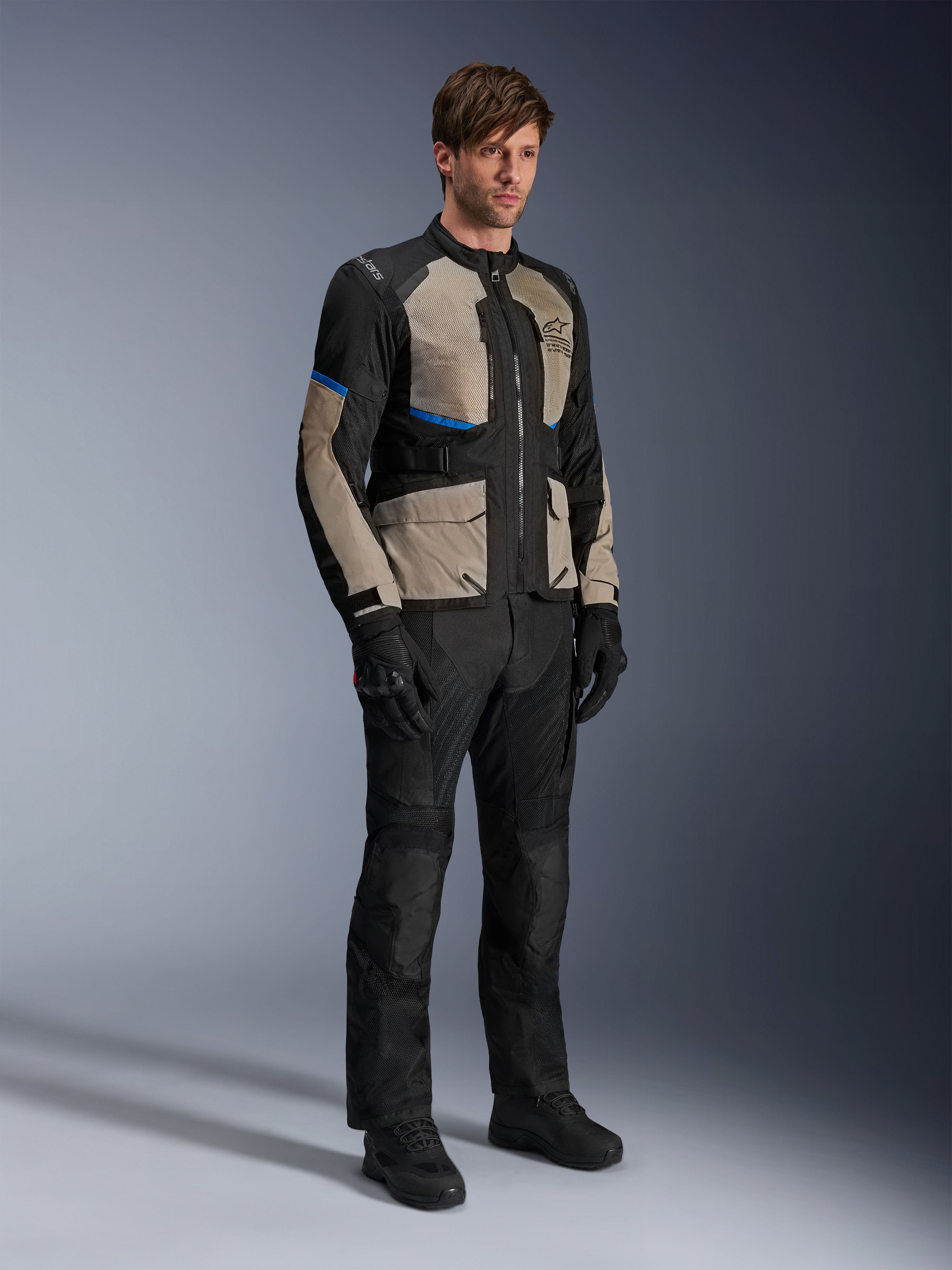 Veste Alpinestars Andes Air Drystar®, veste de touring moto, Noir Laurel Gray et Bright Blue, portée avec un pantalon et des gants assortis, dotée de larges panneaux en maille pour la circulation de l'air et d'une coupe orientée route, équipement de touring aventure