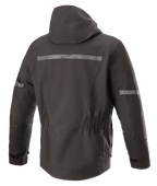 Alpinestars Sirius Drystar® Techshell Jacket, Motorcycle Jacket, Melange Black, back view featuring an integrated hood, reflective strip with Alpinestars logo, elasticized waist, and elongated rear for riding coverage.