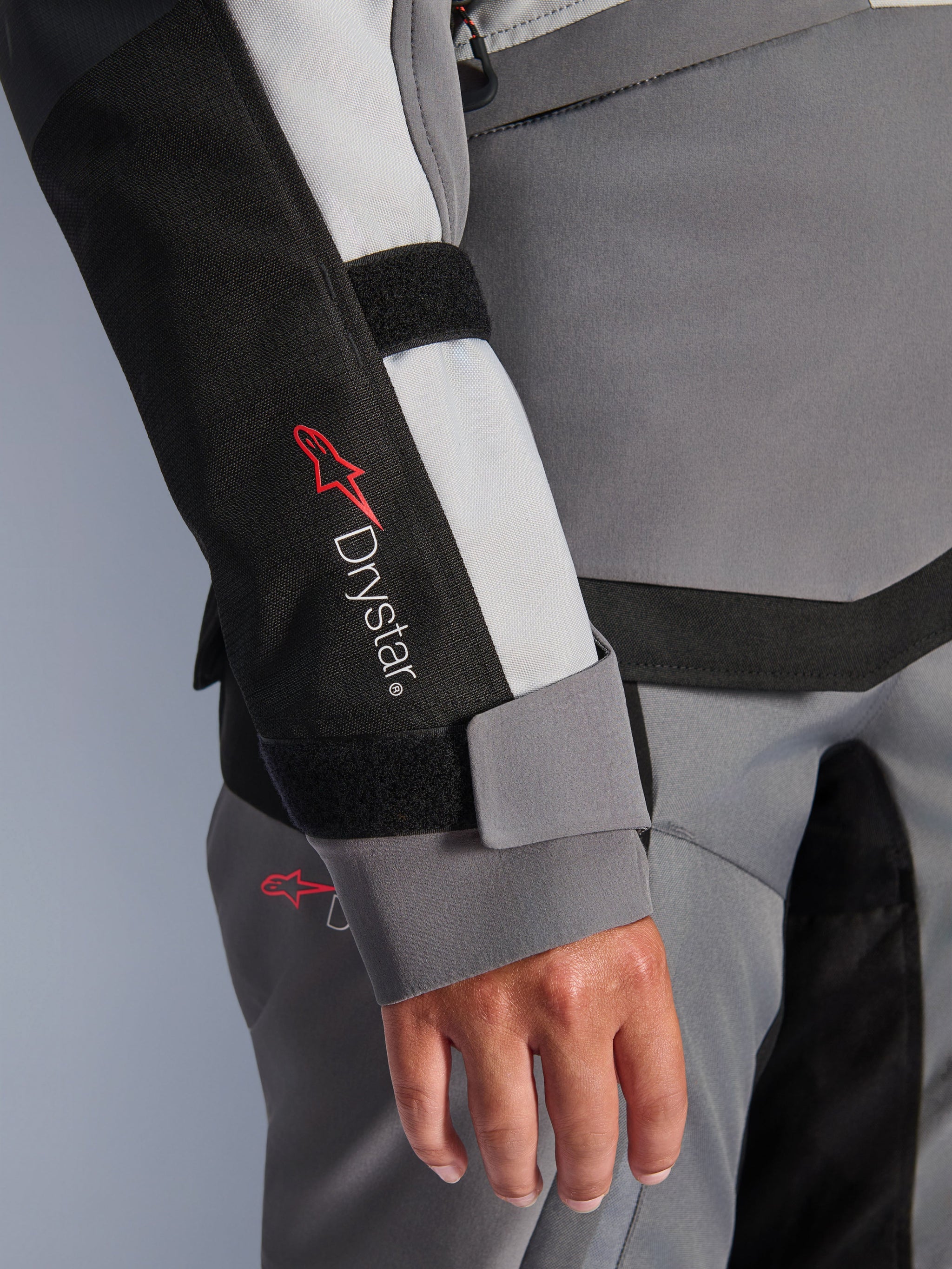 Alpinestars Stella Andes V4 Drystar® Jacket, women's gray textile adventure sleeve with logo and velcro wrist closure.