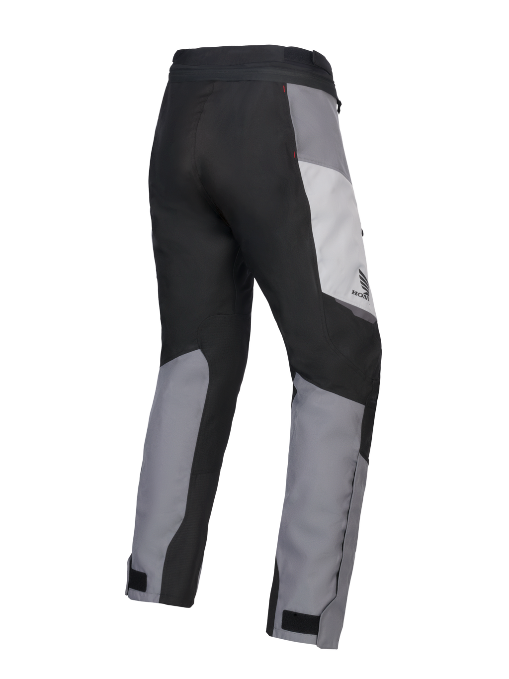Pantalon Alpinestars 2025 Honda Stella ST-1 Waterproof pour femme, pantalon de touring moto, gris glace, gris foncé et noir, vue de trois-quarts arrière montrant la construction textile durable, les empiècements contrastés gris et noirs, le logo Honda sur la hanche et les pattes de serrage aux chevilles.