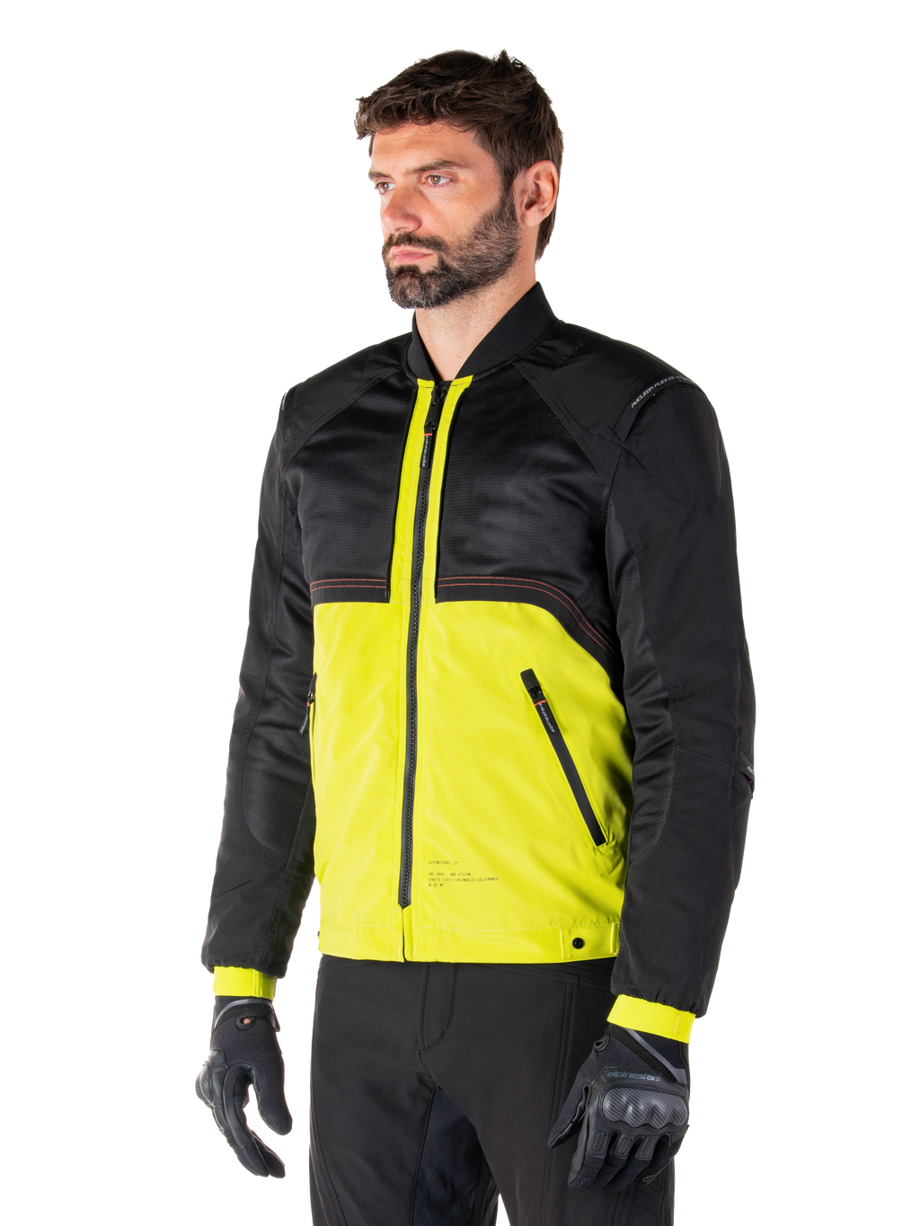 Parka imperméable Alpinestars Mootant en Lime Punch Black, veste de moto modulaire avec une partie supérieure en maille noire et une partie inférieure vert lime vif, portée par un pilote avec des gants et un pantalon noirs, style urbain contemporain
