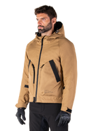 Alpinestars Morush Waterproof Parka, Utility Brown, male model wearing parka with black riding gloves and black pants, minimalist streetwear-inspired design featuring a stormproof hood and large front pockets, waterproof motorcycle apparel