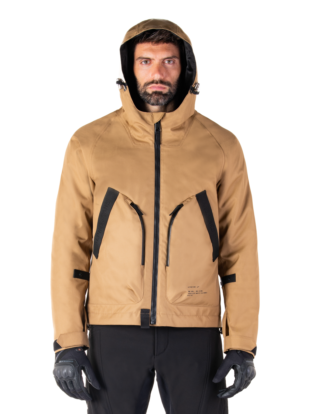 Alpinestars Morush Waterproof Parka, Motorcycle Jacket, Utility Brown, hooded streetwear-inspired design with large black-accented front pockets, worn with black riding gloves and pants, urban contemporary motorcycle gear