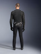 Alpinestars T-Sps Air V2 Jacket, Rear View, Black and White textile motorcycle jacket, featuring a large mesh back panel for maximum airflow and white Astars logo on the lower back, worn with black riding pants and gloves
