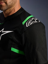 Veste Alpinestars T-SPS Air V2, noir et vert fluo, gros plan sur l'épaule et le torse, logo étoile Alpinestars blanc, maille technique pour la circulation de l'air, veste de moto sportive