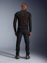 Alpinestars Troop-Air Pro Jacket in Black Red Fluo, rear view on model, technical armored mesh jacket with breathable panels, red logo on upper back, worn with black pants and sneakers, urban motorcycle apparel