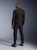 Alpinestars Troop-Air Pro Jacket in Black Red Fluo, rear view on a model, featuring a large 2D tech mesh back panel with visible red interior, paired with black technical riding pants and black/grey boots, modern urban armored motorcycle jacket design.