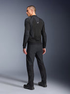 Veste Alpinestars Troop-Air Pro, noire, veste technique blindée et ventilée vue de dos, avec de larges panneaux en mesh pour la circulation de l'air, accompagnée d'un pantalon technique et de chaussures noirs assortis.