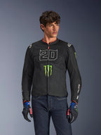 Alpinestars FQ20 T-SPS Air V2 Monster Jacket, Black motorcycle jacket with large white '20' and green Monster Energy logo, worn by a male model with dark jeans and matching gloves, lightweight mesh construction for urban riding