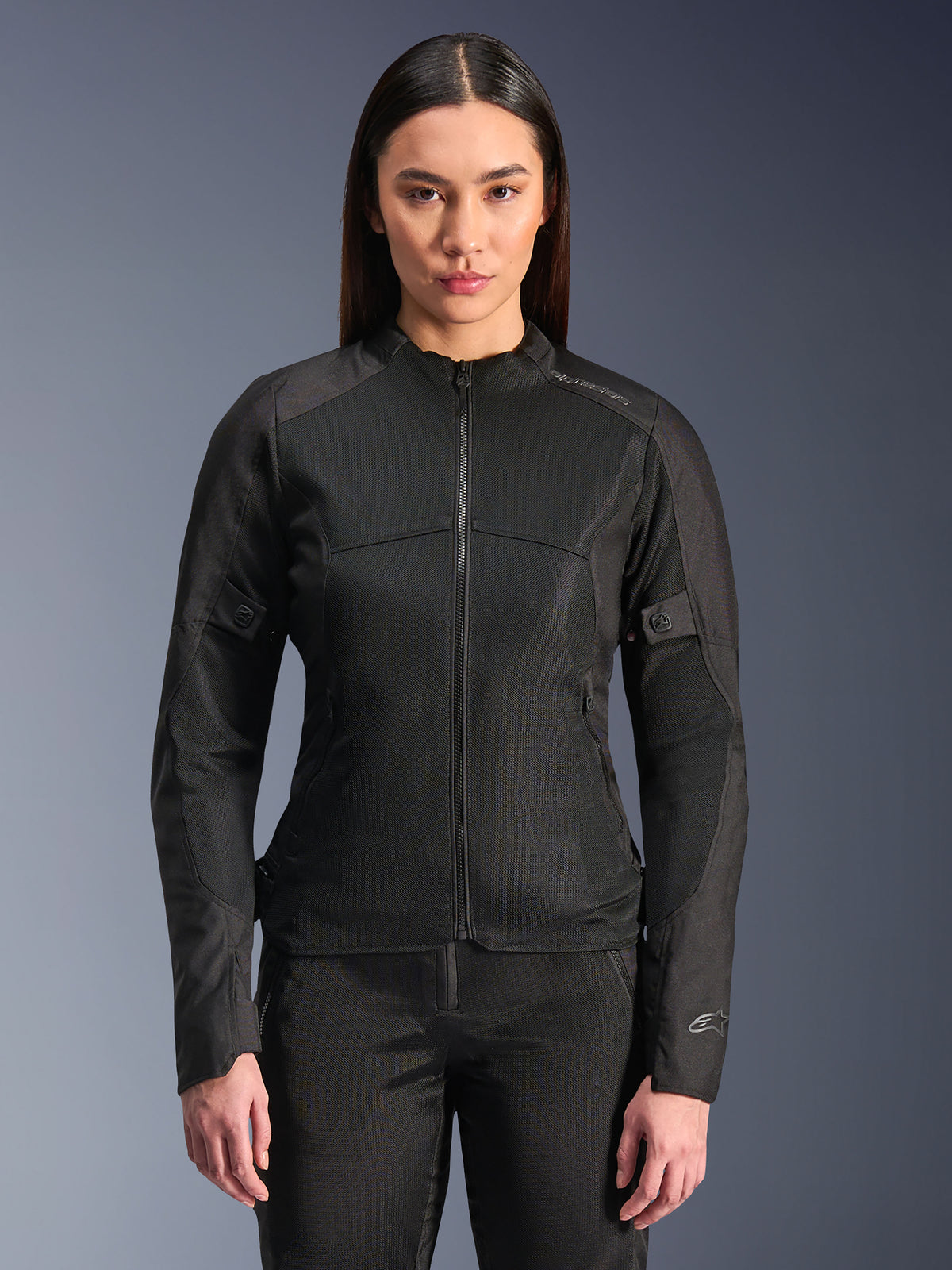 Alpinestars Stella C-1 Air Jacket, Women's Motorcycle Jacket, Black, model wearing a sleek zipped jacket with tech mesh panels, slim fit design with subtle reflective logos on the shoulder and sleeve cuff