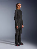 Alpinestars Woman Stella C-1 Air Jacket in Black, textile motorcycle jacket with mesh panels, worn with matching black riding pants and technical sneakers, studio shot showing a full-length urban riding outfit.