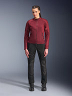 Alpinestars Woman Stella C-1 Air Jacket, Burgundy textile motorcycle jacket, featuring mesh panels for ventilation and zippered pockets, worn by model with black riding pants and boots, urban contemporary riding gear for women