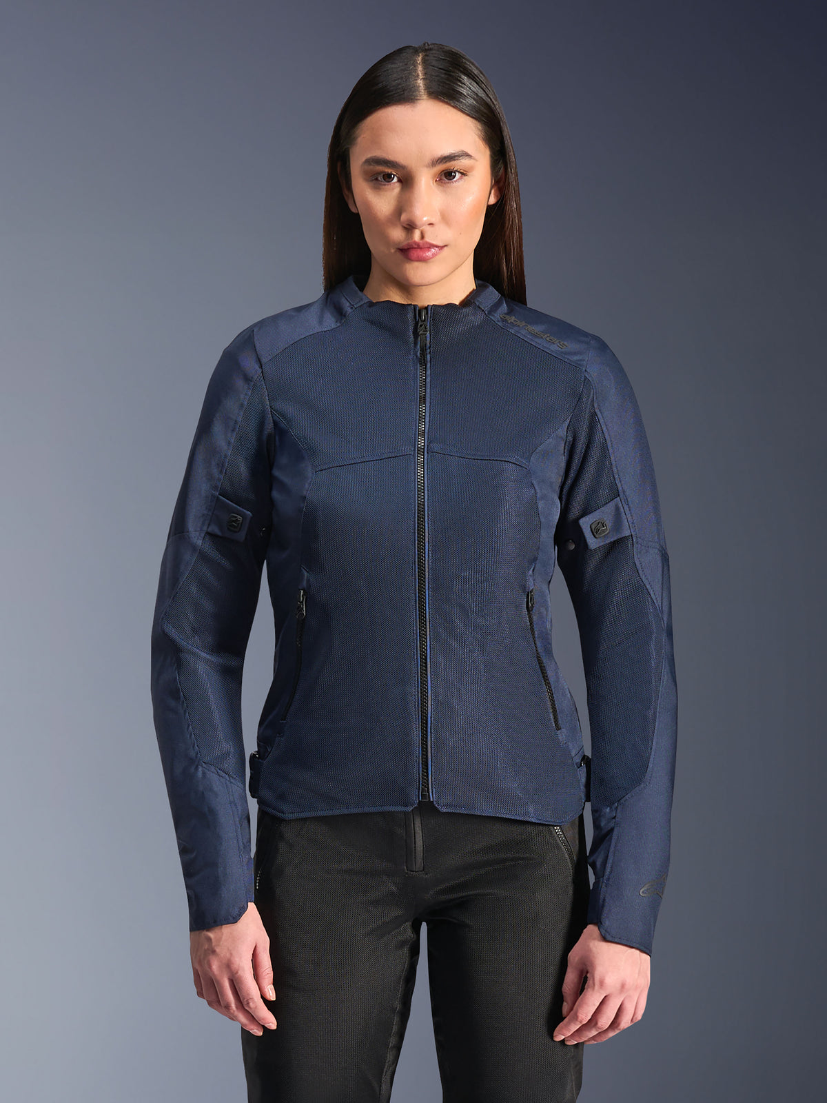 Alpinestars Stella C-1 Air Jacket in Blue, Women's Motorcycle Jacket, modeled with black riding pants, features large mesh panels for airflow, zippered front and side pockets, and a clean contemporary design.