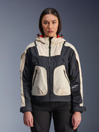 Veste Alpinestars Molly Air, veste de moto urbaine pour femme, Black Almond, vue de face sur un modèle, avec empiècements ripstop crème et noirs, capuche avec doublure orange, fermeture éclair centrale et grandes poches utilitaires, équipement de moto d'inspiration streetwear contemporaine
