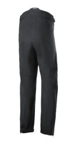 Pantalon Alpinestars AMT Storm Gear Drystar® XF, surpantalon de moto noir, vue arrière avec fermeture éclair de raccordement à la taille sur toute la circonférence, ourlets élastiqués et ouvertures de jambe zippées pour la conduite par temps humide.
